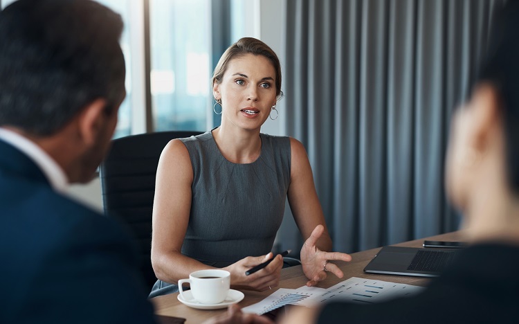 woman in a meeting with non-facing colleagues