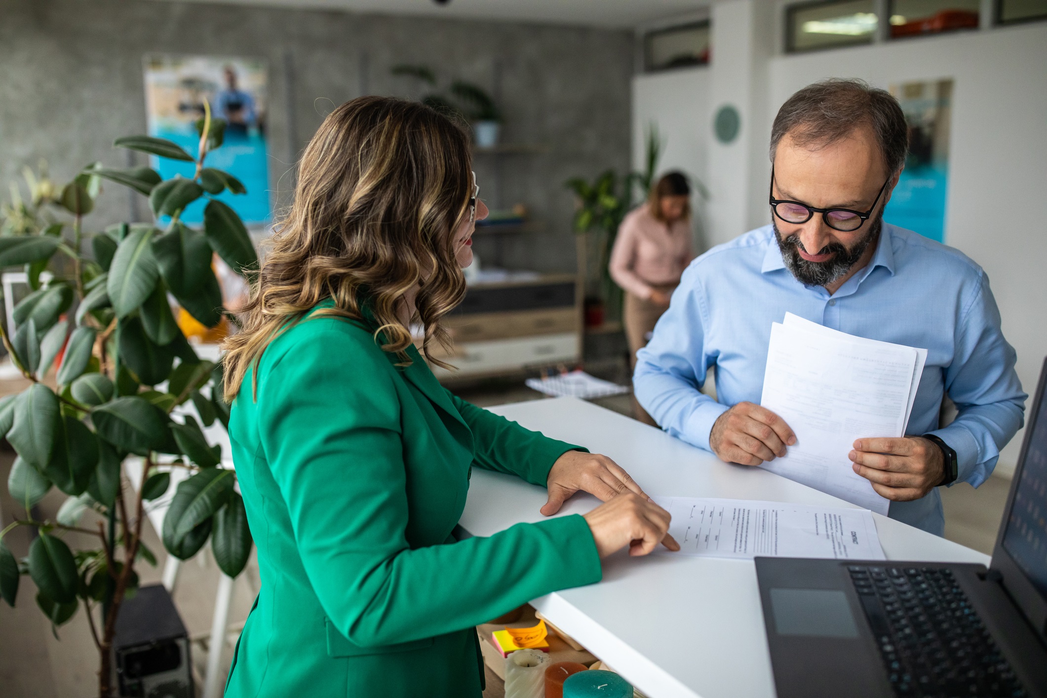 colleagues discussing paperwork