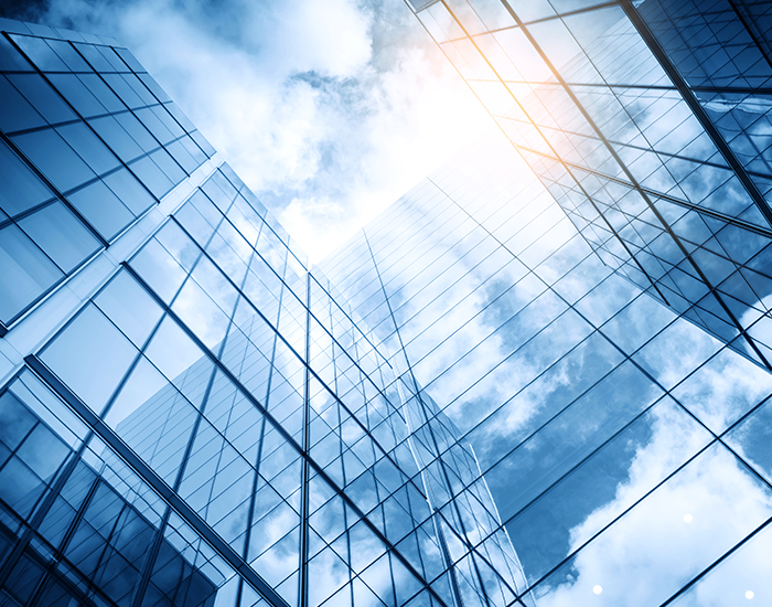 looking up to the sky between commercial buildings