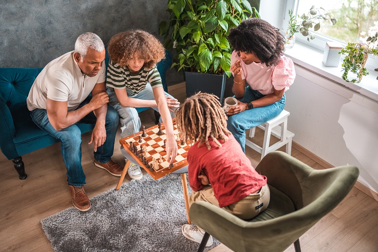 bird's eye view of family playing chess